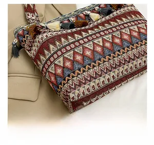 Macro detail of bohemian woven tote bag with ethnic patterns and colorful fringe accents