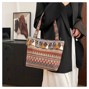 Detail of bohemian tote bag featuring ethnic jacquard patterns and vibrant colorful tassels