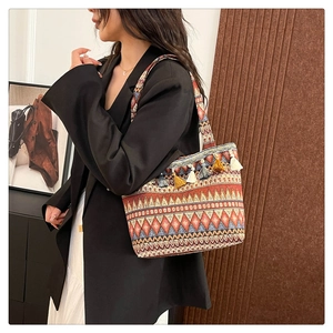 Close-up of colorful ethnic woven jacquard tote bag with vibrant decorative tassels