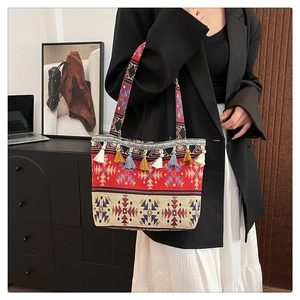 Close-up of bohemian tote bag featuring colorful tassels and geometric jacquard patterns