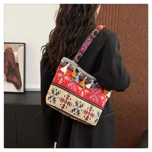 Detailed shot of ethnic tote bag with colorful tribal patterns and fringe tassels