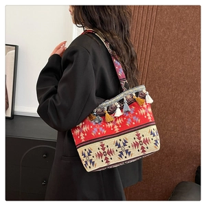 Close-up of geometric jacquard fabric and colorful tassels on ethnic tote bag
