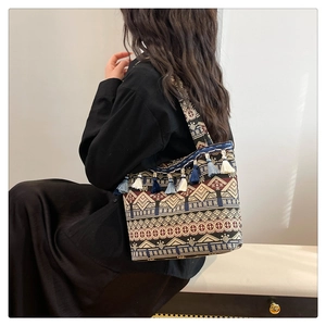 Close-up of a bohemian tote bag with ethnic geometric patterns and colorful tassels