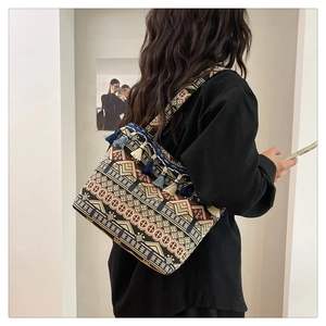 Close-up of ethnic tote bag with geometric patterns and decorative fringe detail