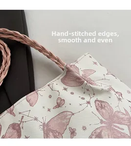 Detail showing hand-sewn edges and woven rope handle on butterfly print tote bag