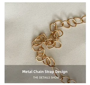 Detail showing the polished golden metal chain strap on a textured fabric background