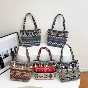 Set of bohemian woven tote bags with colorful tassels and ethnic geometric patterns