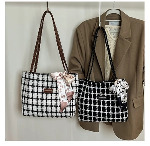 Detail view of plaid tweed tote bags with woven leather straps and cherry print silk scarves