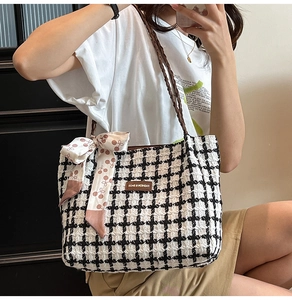 Checkered tweed tote bag with cherry scarf detail shown as a shoulder bag on a model