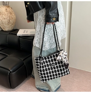 Detail of tweed tote bag with black and white plaid pattern and polka dot scarf detail