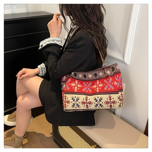 Close-up of geometric ethnic pattern weaving on a bohemian shoulder tote bag for women