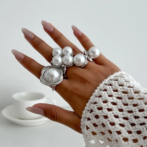 Baroque silver ring set with large white pearls shown on model in elegant French style
