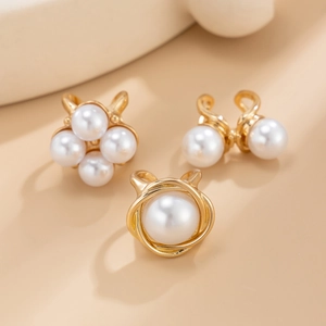 Detailed view of three gold-tone baroque rings featuring elegant faux pearl embellishments
