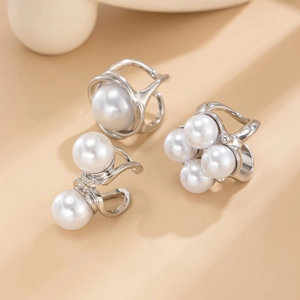 Baroque silver metal ring set with elegant white pearls in a minimalist modern style