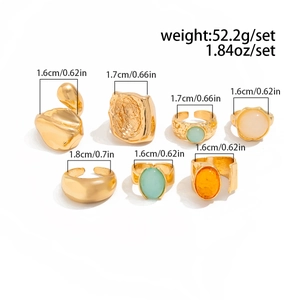 Detailed set of 7 vintage gold rings featuring hammered textures and colorful gemstones