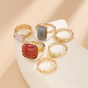 Detail view of a six-piece vintage alloy ring set with colorful acrylic gemstones
