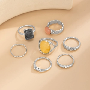 Set of 7 silver rings featuring square and oval gemstones with hammered texture details
