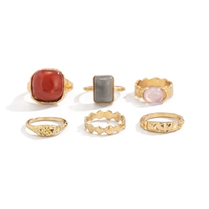 Modern vintage gold ring set featuring colorful gemstones and textured metallic bands