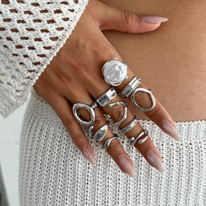 Silbernes geometrisches Ring-Set mit Lava-Textur und weißer Perle am Modell getragen
