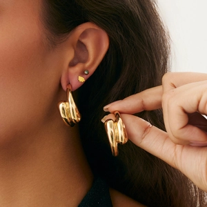 Elegant chunky gold twisted heart earrings with irregular wrinkled metallic surface