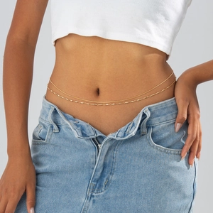 Detail view of a double-layered golden waist chain featuring delicate bead and disc charms