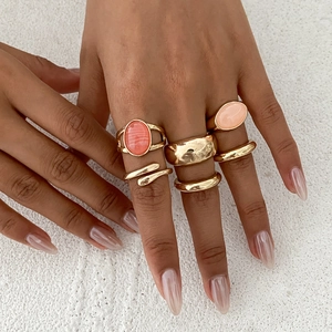 Set of 6 minimalist gold-plated irregular rings with oval stones on model hands