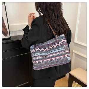 Close-up of bohemian tote bag with colorful geometric patterns and leather straps