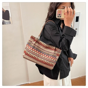 Close-up of ethnic geometric jacquard tote bag with red and blue diamond patterns