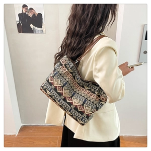 Close-up of geometric jacquard fabric and brown leather straps on an ethnic tote bag