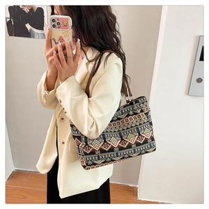Detailed view of large ethnic patterned tote bag with geometric embroidery and top handles