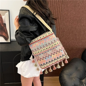 Détail du sac bohème tissé avec des motifs géométriques colorés et de longues franges