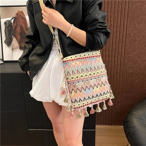 Détail du sac à bandoulière tissé bohème avec motifs zigzag et franges multicolores