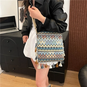 Vue détaillée du motif bohème tissé et des franges colorées du sac ethnique