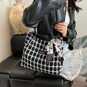 Fashion black and white tweed tote bag with chain handles and cherry print silk scarf detail