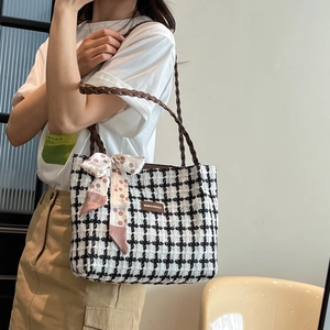 Black and white plaid tweed tote bag with woven handles and decorative silk scarf
