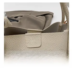 Close-up of litchi grain beige bucket bag with Fashion embossed flap and neat stitching