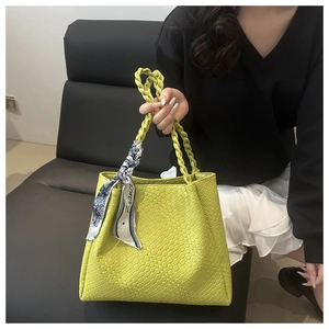 Detail of yellow woven tote bag with knotted handle and France silk scarf accent