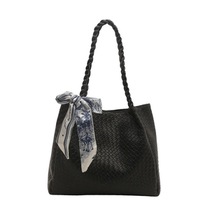 Chic black woven leather tote bag for women featuring a floral silk scarf on handle