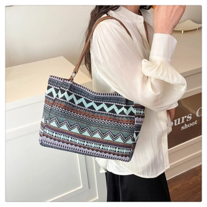 Detail of colorful geometric woven canvas tote with vintage leather shoulder straps