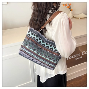 Ethnic geometric pattern tote bag detail with brown leather strap on model