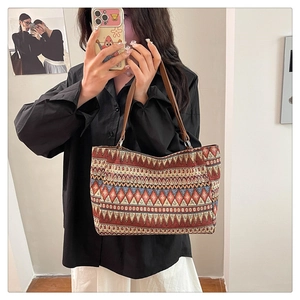 Close-up of ethnic geometric pattern weaving on the retro square tote shoulder bag
