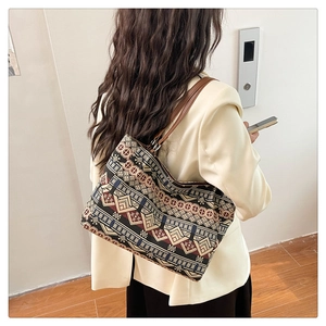Ethnic pattern tote bag with bohemian geometric prints shown on a model's shoulder