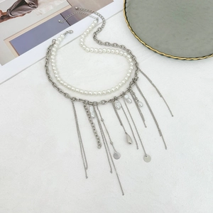 Detail of layered tassel necklace with pearls, silver chains and teardrop pendants