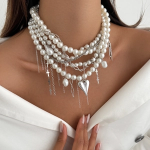 Layered faux pearl necklace with silver heart pendant and cross charms in baroque style