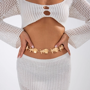 Detailed view of a gold waist chain featuring sea shells, starfish and white pearls