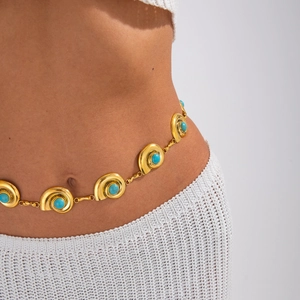 Close-up of golden waist chain featuring turquoise inlays and spiral metal disks