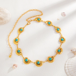 Detailed macro shot of bohemian gold sea shell belt with turquoise stone inlays