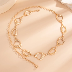 Close-up of golden lava-inspired irregular metal waist chain with textured oval links