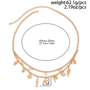 Detail of layered gold waist chain with starfish, shell charms and pearl beads