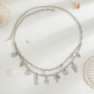 Close-up of double-layer silver waist chain with starfish, shell pendants and pearls